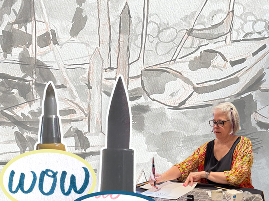 close up example of sumi ink painting is faded in the background, while tips of brush pens and image of woman painting at a table are in the foreground